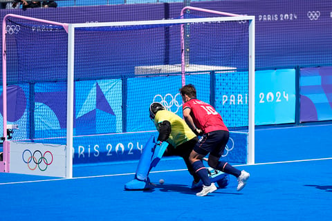 India's goalkeeper Sreejesh prevents Spain's Jose Basterra, right, from scoring 